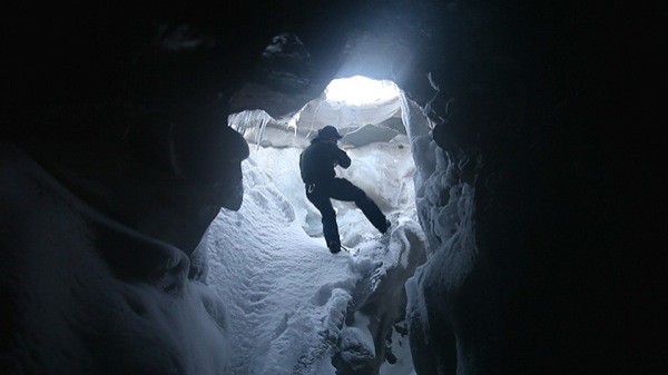 Above, a still from Biggs' 'In the Cold Edge' at Winkleman Gallery — in which the artist follows an explorer into an icy Arctic cave.